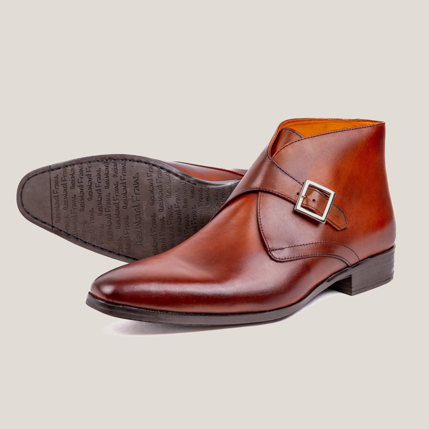 Reinhard Frans Stockholm cognac brown leather monk strap boots with silver buckle detail.
