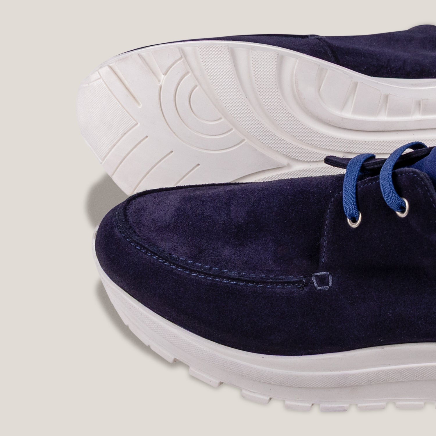 Close up of the Jacobs sole and toe end of the Soho 01 laced design slip on sneakers with a white sole